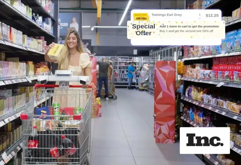 Woman selecting groceries from the shelf and placing in cart with Shop-E on it.